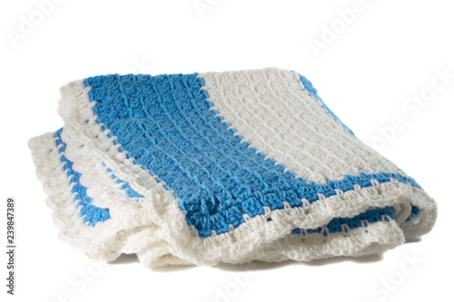 Handcrafted blue and white crochet afghan throw blanket isolated on a white background