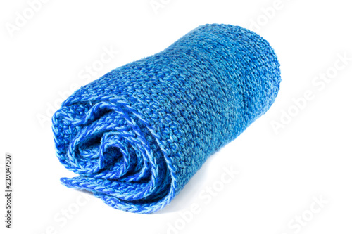 Rolled Handcrafted Blue variegated crochet afghan throw blanket isolated on a white background