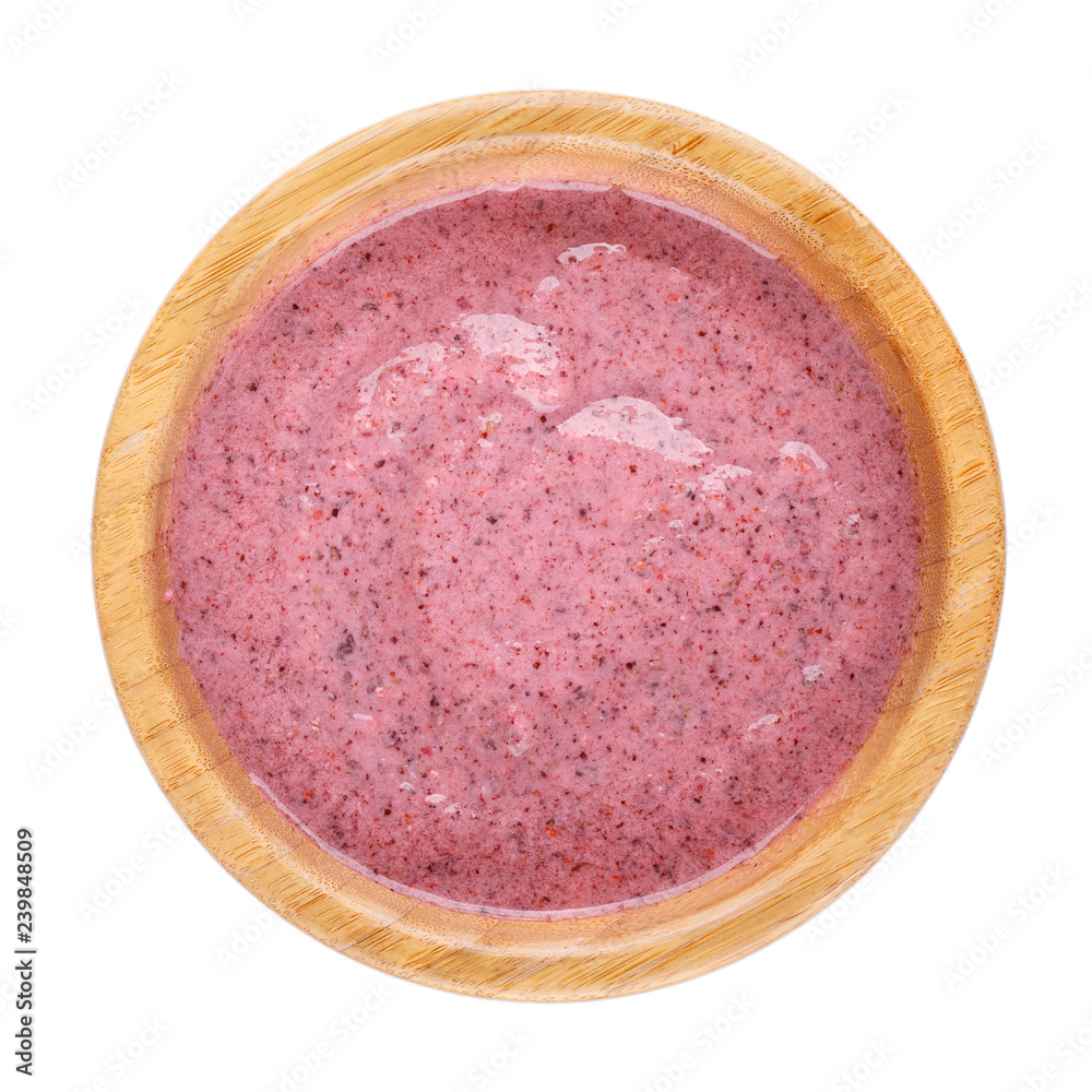 Smoothie bowl isolated on white background. Delicious pink berry smoothie. Healthy breakfast. Top view.