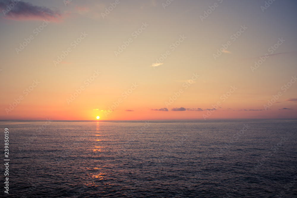 romantic atmosphere sunset sea water surface to horizon board with yellow and orange evening sky nature scenic landscape wallpaper pattern with empty space for copy or text
