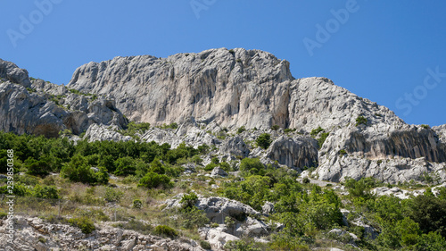 Mountain landscape with rugged white limestone cliffs on a sunny summer day, Biokovo mountain range in Croatia. 