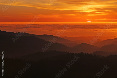 Coastal Californa Sunset over Mountains and Foggy Pacific Ocean photo