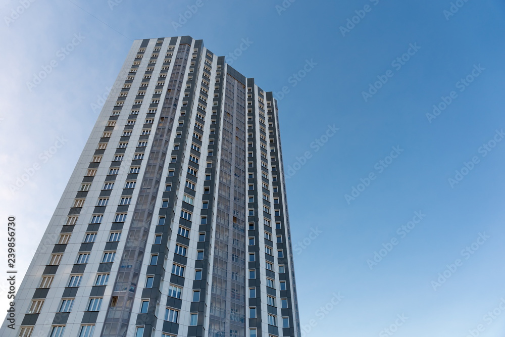 Multi-storey residential building against the blue sky. Multi-storey residential building against the blue sky.