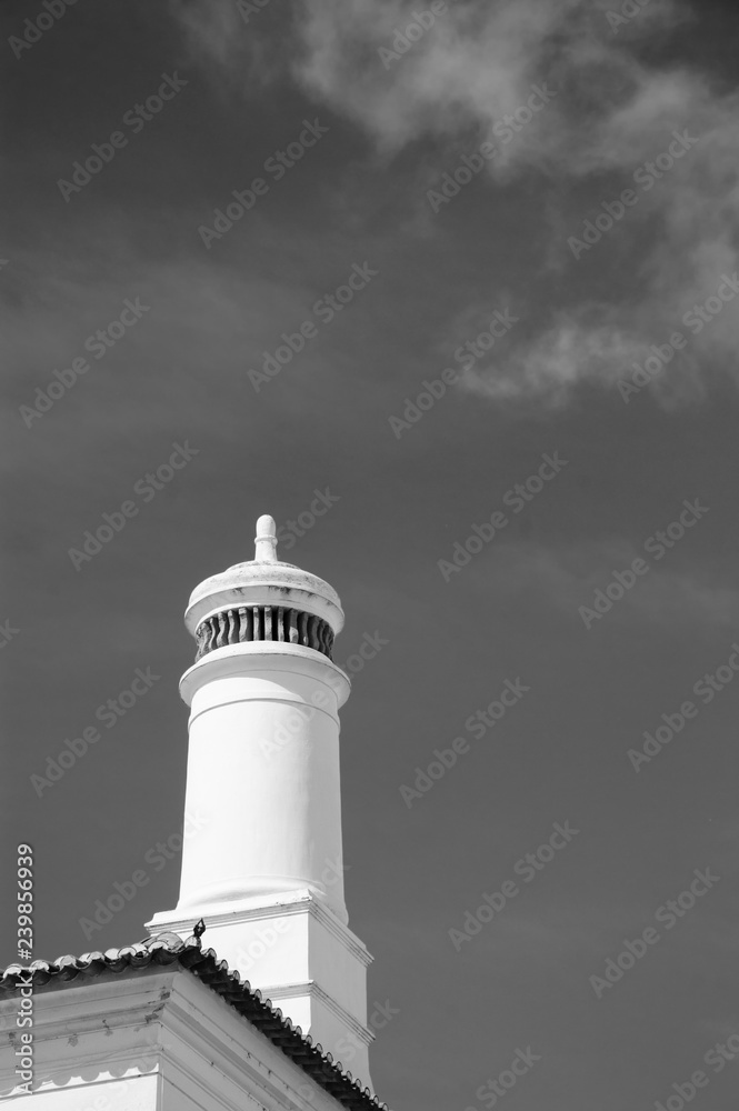 Heating systems. Chimney on the traditional Portuguese house. Real estate in Portugal. Evora, Portugal. Heating systems and ecology concepts. Environment background. Black white historic photo