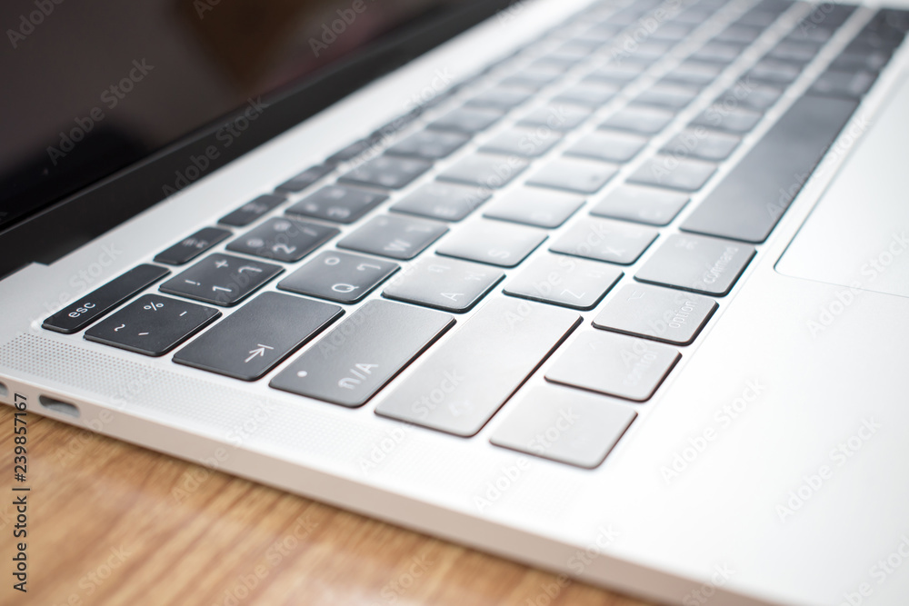 Close-up up of Thai keyboard image on a tablet computer on a wood table in a room.