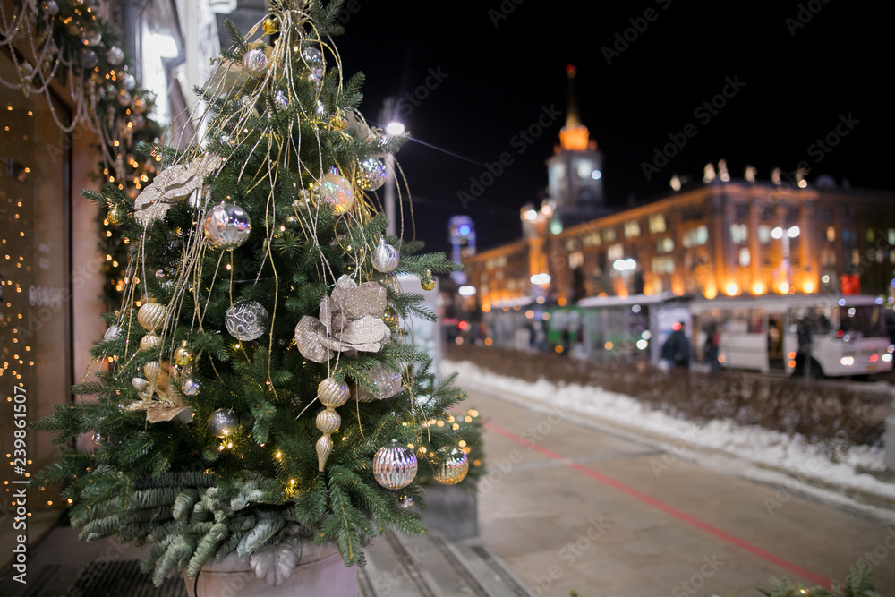 Decorated Christmas tree on  blurred, sparkling and fairy background