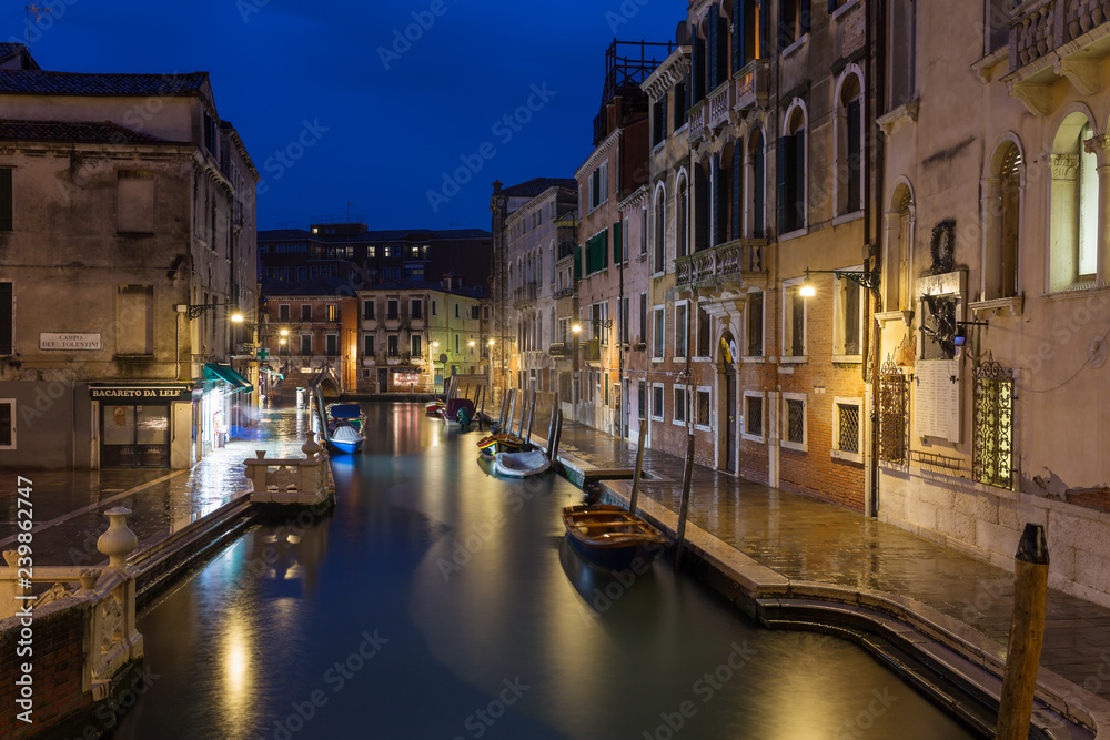 Venice, Italy - March 18, 2018: Side Canal at night in Venice, Italy.