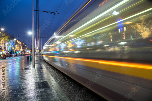 Passing Tram in a City Centre Decorated for Christmas at Night. Dublin, Iraland