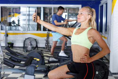 Fototapeta Naklejka Na Ścianę i Meble -  Woman taking selfie at gym