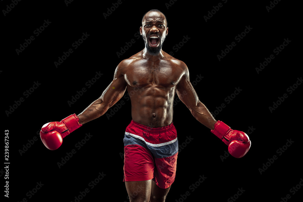 Hands of boxer over black background. Strength, attack and motion concept. Fit african american model in movement. Afro muscular athlete in sport uniform. Sporty man during boxing