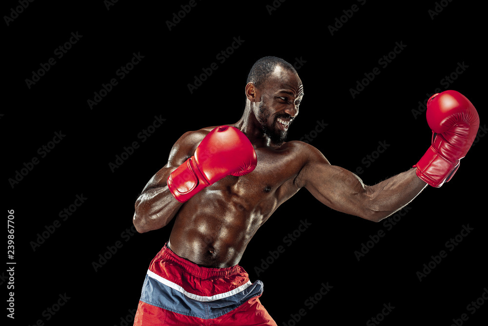 Hands of boxer over black background. Strength, attack and motion concept. Fit african american model in movement. Afro muscular athlete in sport uniform. Sporty man during boxing