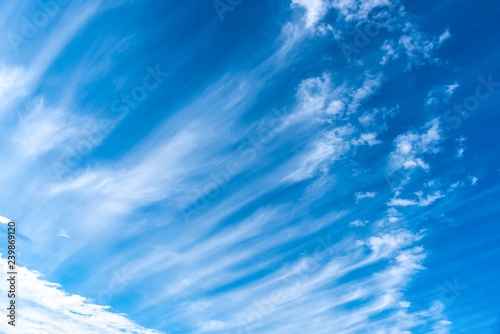Blue sky with clouds background.