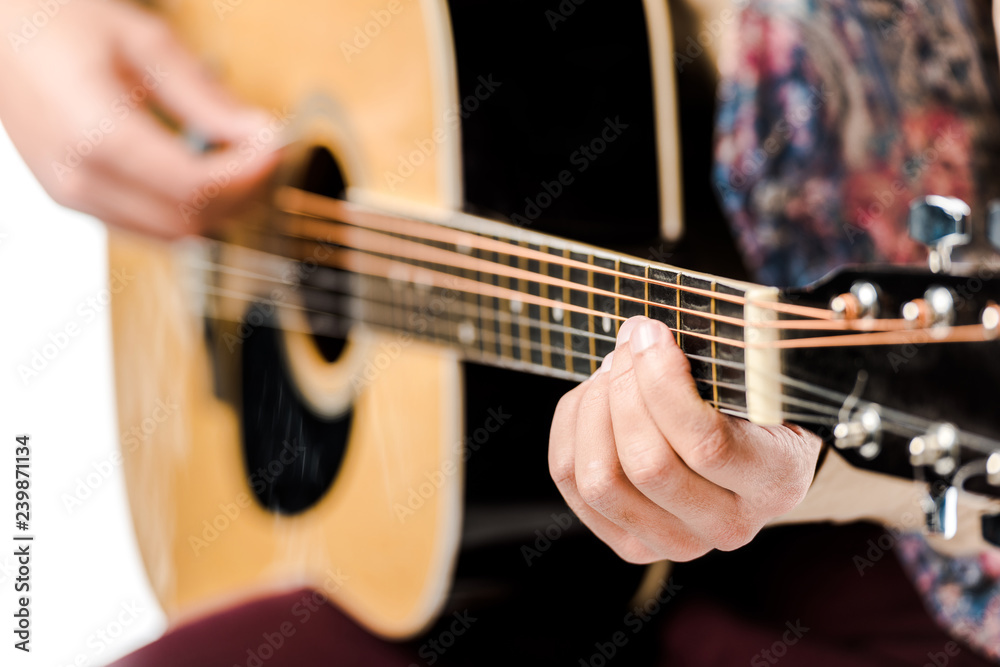 selective focus of male musician playing on acoustic guitar isolated on white