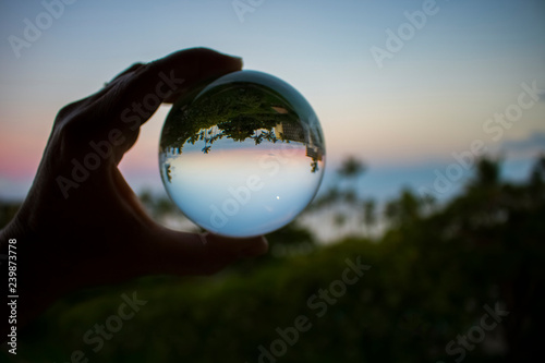 Sunset over Ocean with Full Moon Captured in Glass Ball © Erin