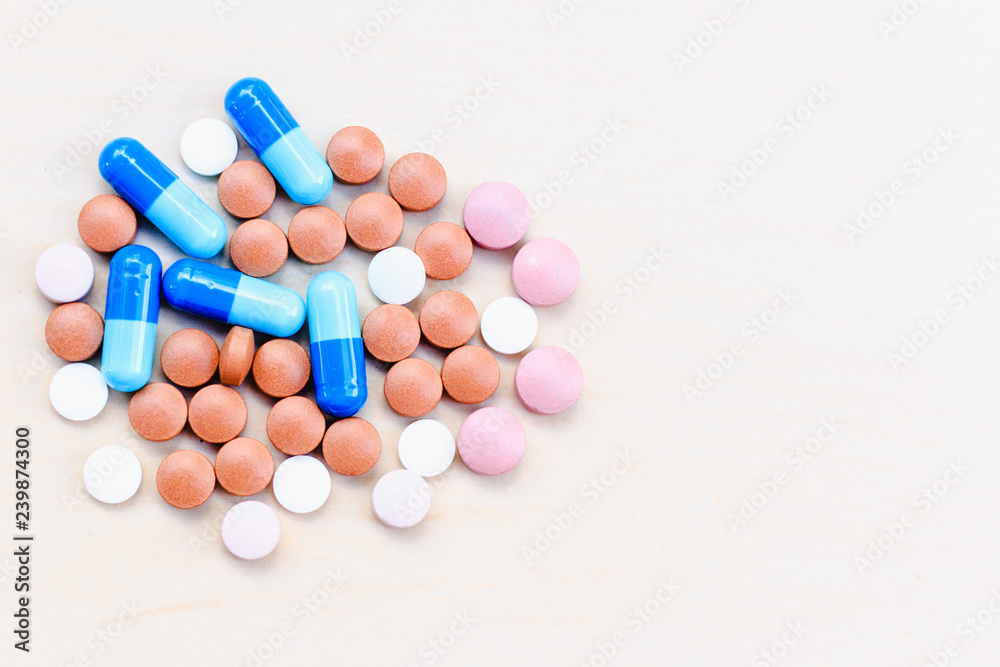 Assorted pills (medicine) on a light background. Top View.
