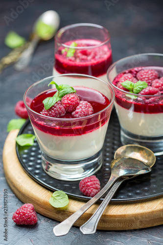 Panna cotta with berry sauce, raspberries and fresh mint.