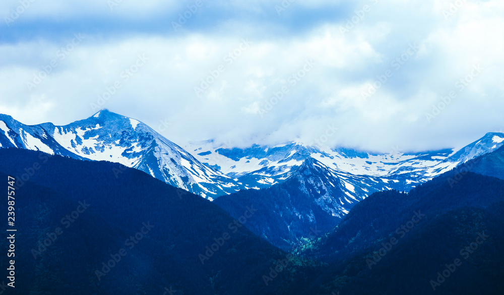Fototapeta premium Beautiful alpine ice mountains peaks with snow, summer time, blue sky background.