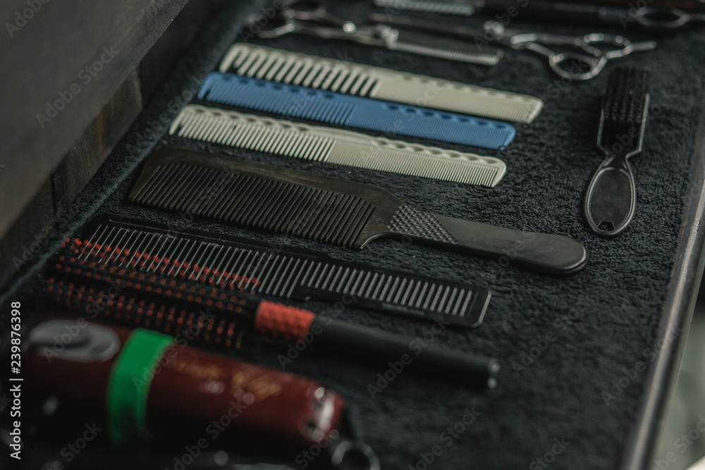 Close up of five combs and brushes lying on the towel Close up of five combs and brushes lying on the towel