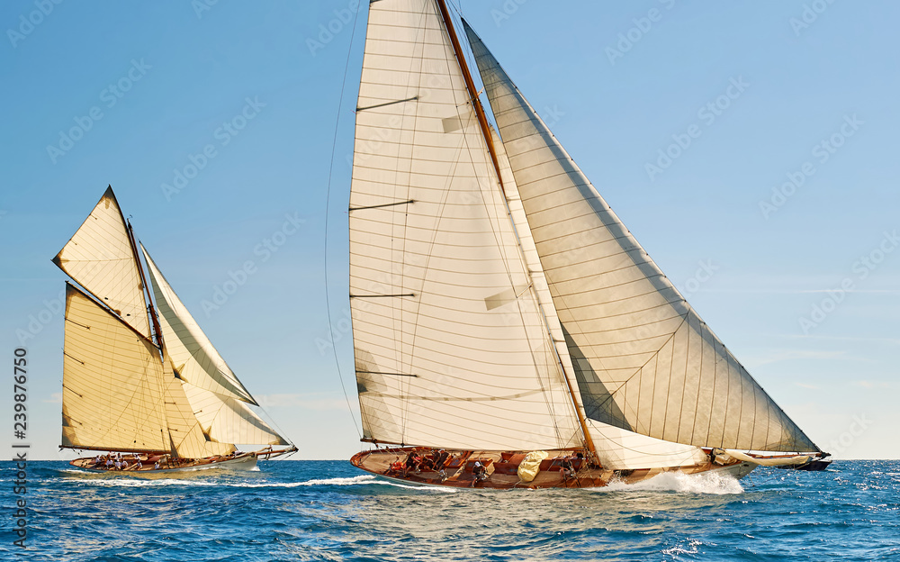 Sailing yacht race regatta. Classic sailboats in the sea under sail. Yachting sport and travel Sailing yacht race regatta. Classic sailboats in the sea under sail. Yachting sport and travel