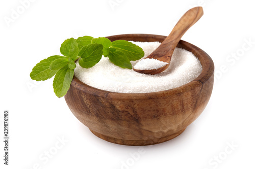 Stevia rebaudiana, sweet leaf sugar substitute isolated in wooden bowl on white background photo
