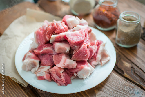 Fresh raw pork sliced on wooden background.