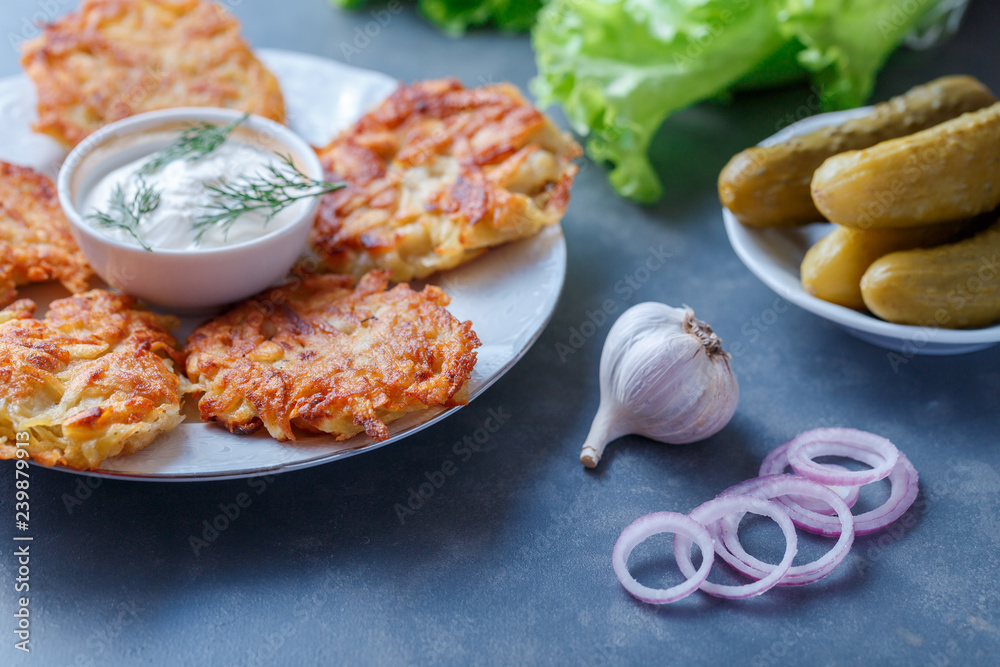 Draniki - potato fritters. potato pancakes lie on a plate. The national dish of Belarus, Ukraine, Russia.