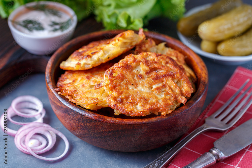 Draniki - potato fritters. potato pancakes lie on a plate. The national dish of Belarus, Ukraine, Russia. Draniki - potato fritters. potato pancakes lie on a plate. The national dish of Belarus, Ukraine, Russia.