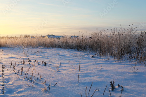 Sunset over the village in winter season