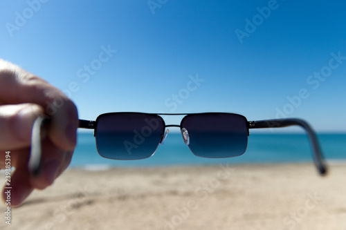 man wearing sunglasses on the beach