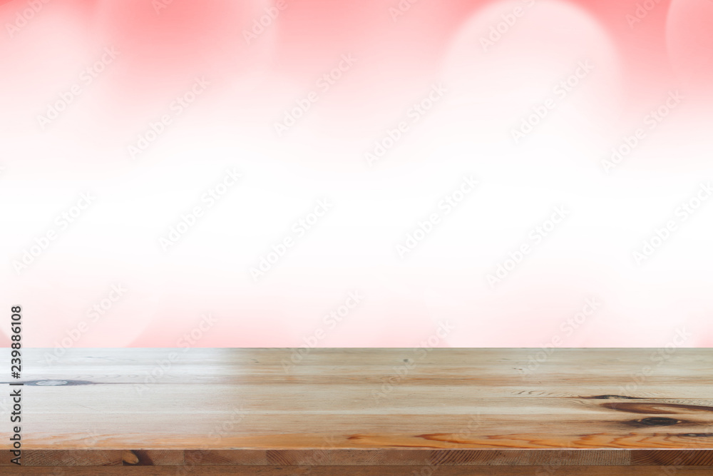 Empty desk with blurred light red gradient bokeh abstract background