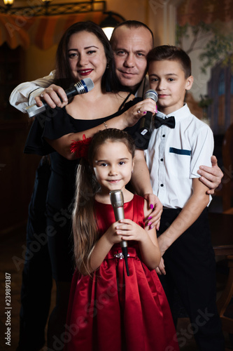 Family karaoke. Portrait of a happy family, singing in microphones