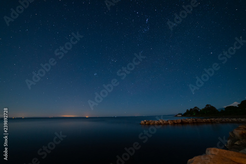 rain of geminid stars along with the wirtanen comet, captured on the shore of Lake Llanquihue 