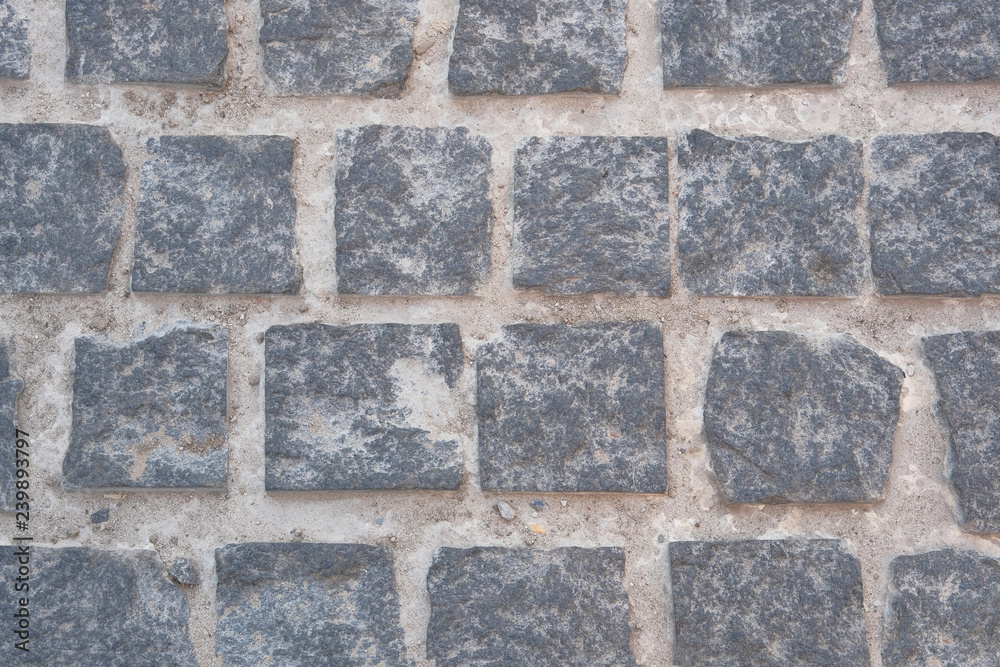 Pavement is lined with old stone. Gray retro stone texture. Ancient brick. Pavement is lined with old stone. Gray retro stone texture. Ancient brick.
