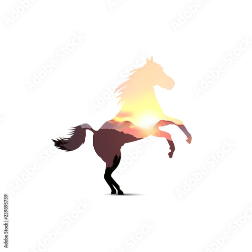 Silhouette of horse with coniferous trees on the background of mountains and colorful sky. Sunset.