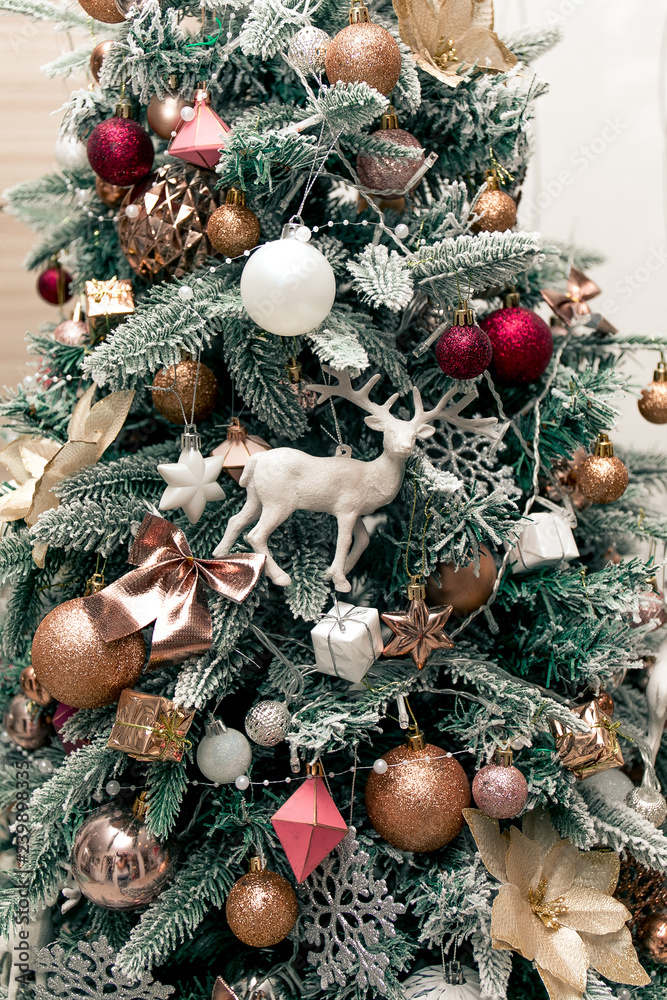 Christmas tree decoration with deers, animals, beads, ornaments, garlands.  Merry Christmas and Happy New Year. Snowy white pine tree. Home Interio.  Stock Photo | Adobe Stock