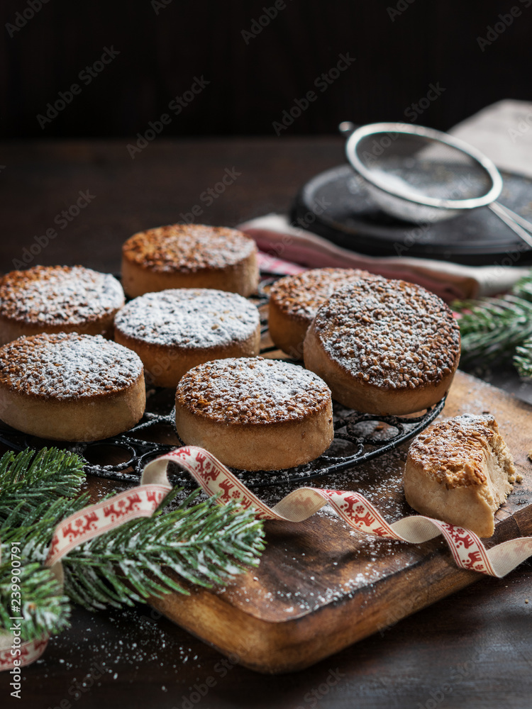 Traditional Christmas cookies with almonds and sesame on dark wooden background