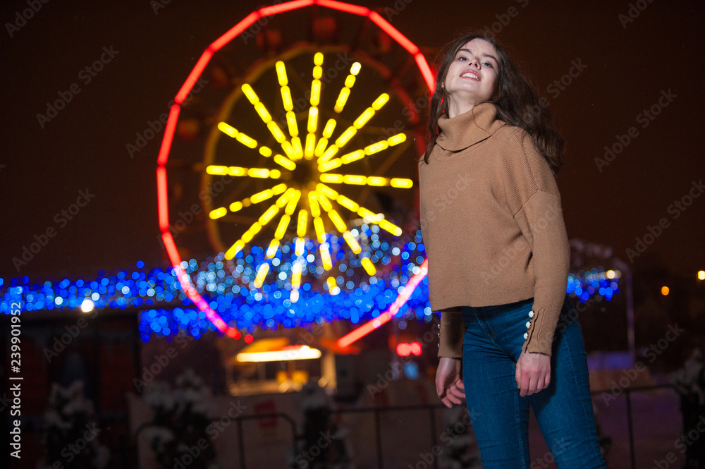 Obraz premium Young girl posing in a amusement park on a winter night.