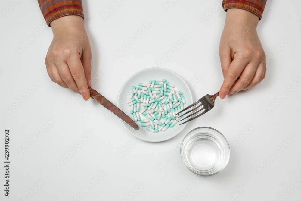 Supplementary food on the dish with fork and spoon Supplementary food on the dish with fork and spoon