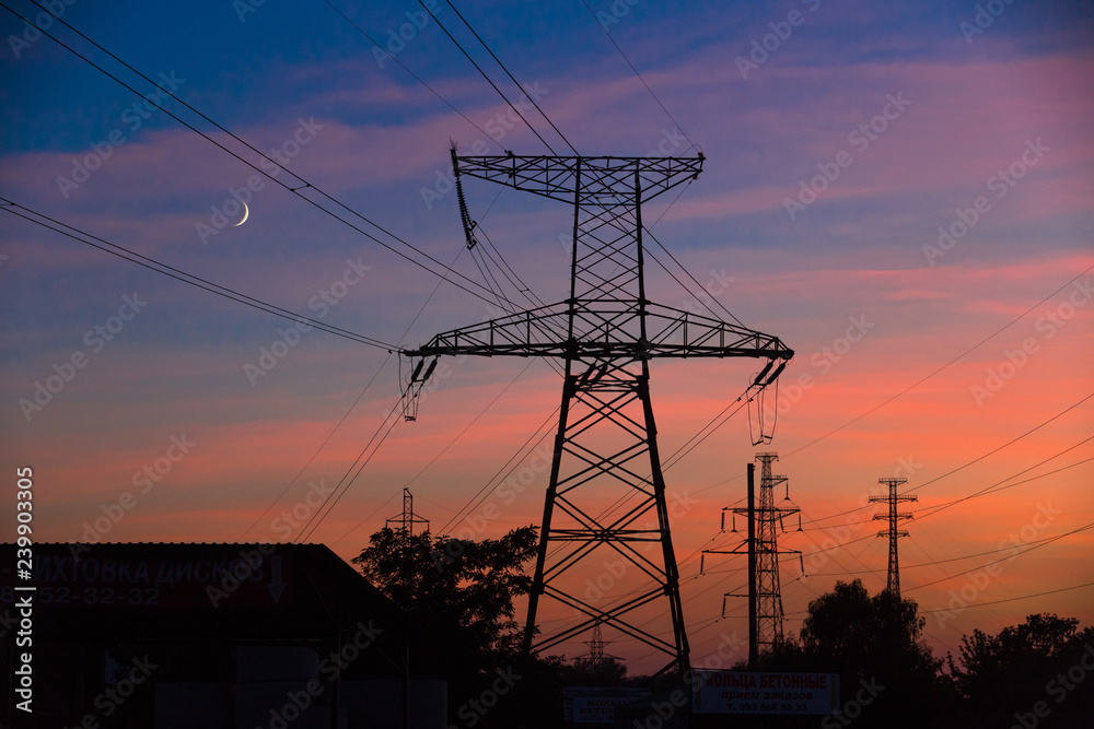 Electrical lines under a night sky with moon