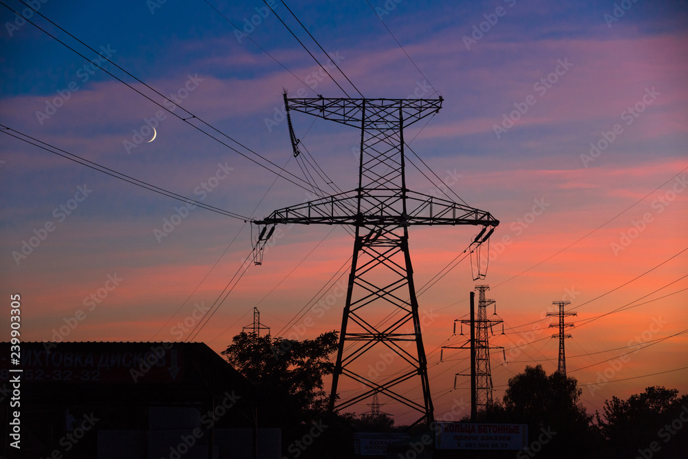 Electrical lines under a night sky with moon Electrical lines under a night sky with moon