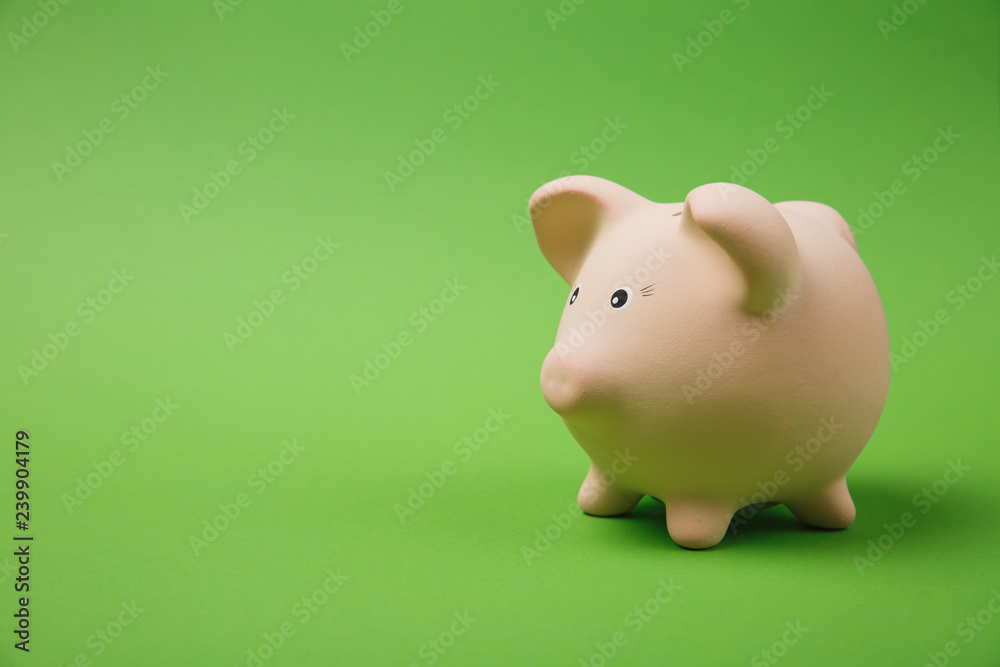 Close up photo side view of pink piggy money bank isolated on bright green wall background. Money accumulation investment, banking or business services, wealth concept. Copy space advertising mock up. Close up photo side view of pink piggy money bank isolated on bright green wall background. Money accumulation investment, banking or business services, wealth concept. Copy space advertising mock up.