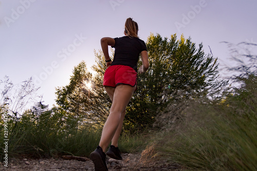 woman running in the mountains at sunset