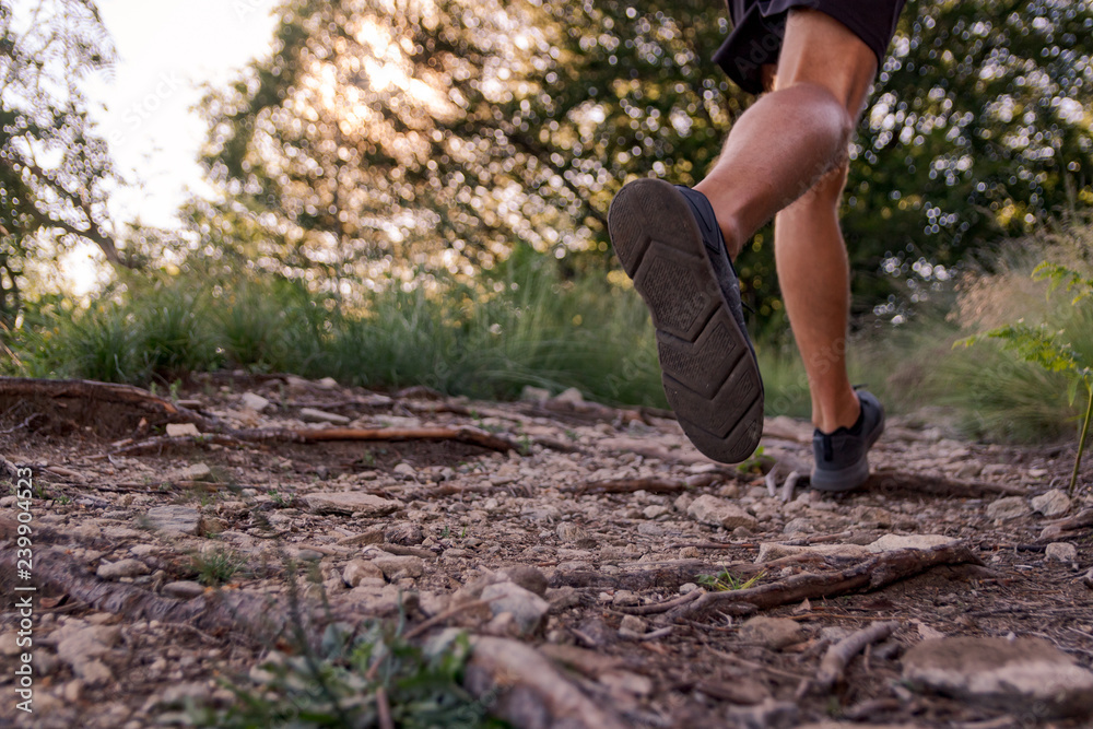 man legs running on trail in the mountains man legs running on trail in the mountains