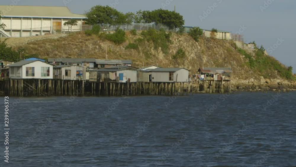 Wide still shot of stilts houses along Moresby port shoreline, Hanuabada village Wide still shot of stilts houses along Moresby port shoreline, Hanuabada village