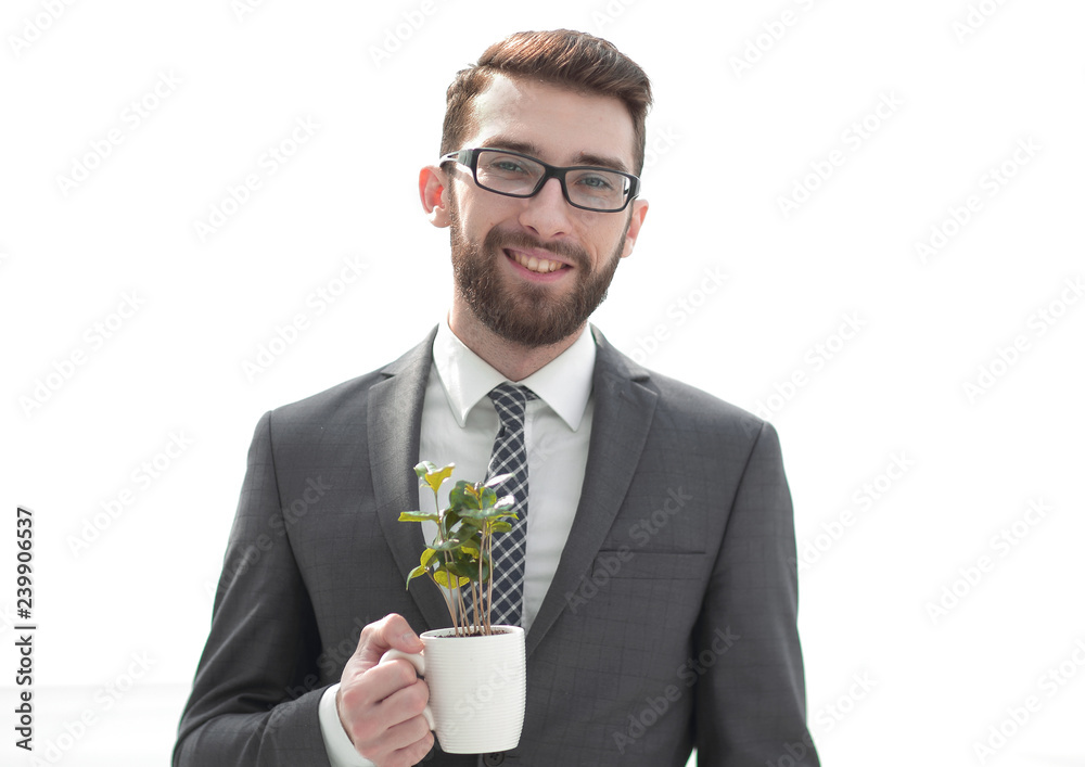 close up.businessman is holding a green young shoot close up.businessman is holding a green young shoot