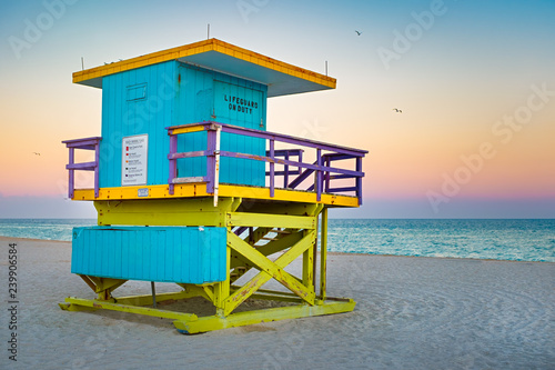 Famous lifeguard tower at South Beach in Miami with a beautiful sunset sky © kmiragaya