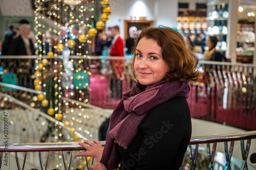 Woman doing Christmas shopping in luxury arcade, London photo