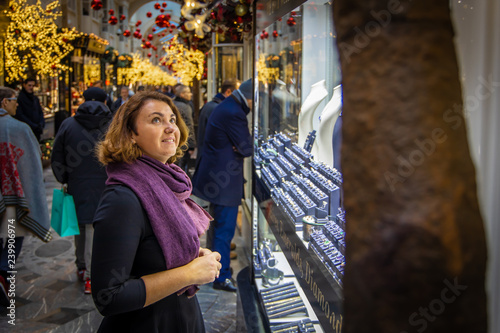 Woman doing Christmas shopping in luxury arcade, London photo