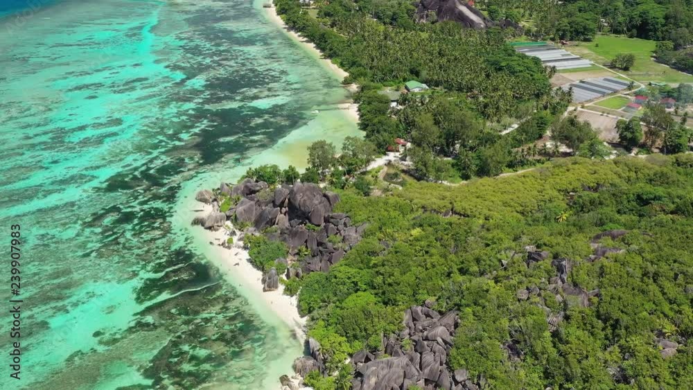 Aerial view of tropical paradise beach with white sand and turquoise crystal clear water of Indian Ocean - Anse Union, La Digue Island, Seychelles Aerial view of tropical paradise beach with white sand and turquoise crystal clear water of Indian Ocean - Anse Union, La Digue Island, Seychelles