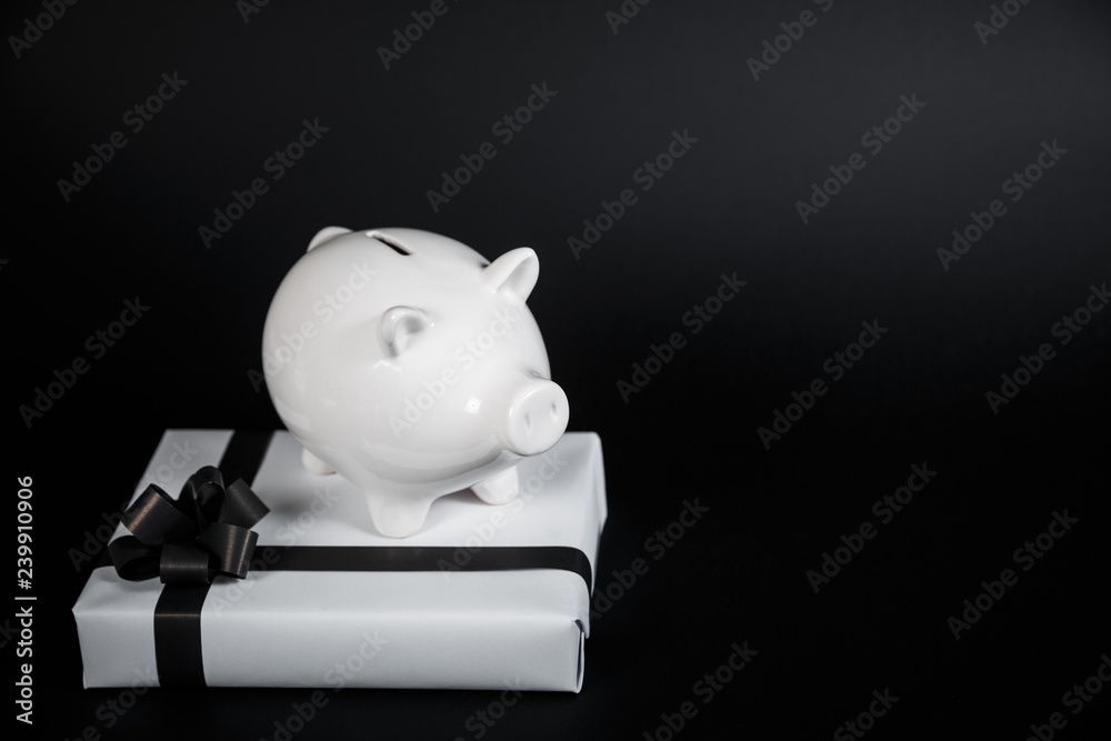 Piggy bank style money box and gifts isolated on black a background. Piggy bank style money box and gifts isolated on black a background.